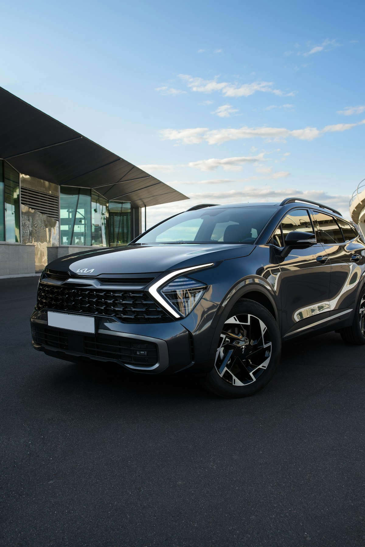 2026 Kia crossover SUV parked outside a modern building