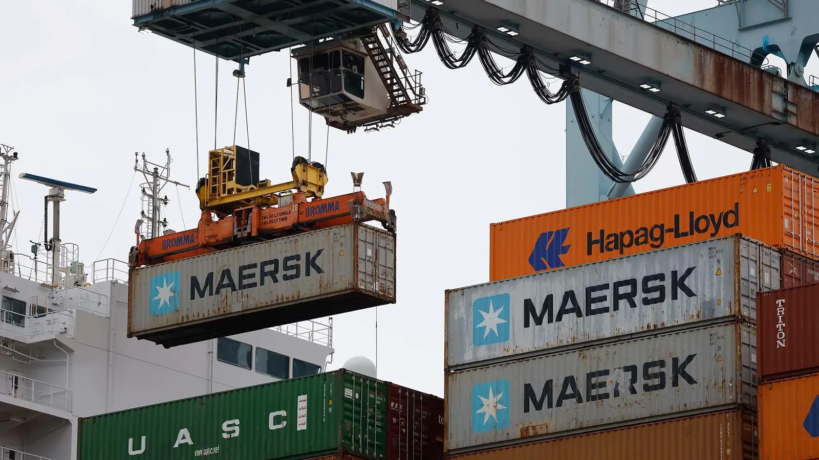 Shipping containers stacked at a US port symbolizing auto import tariffs