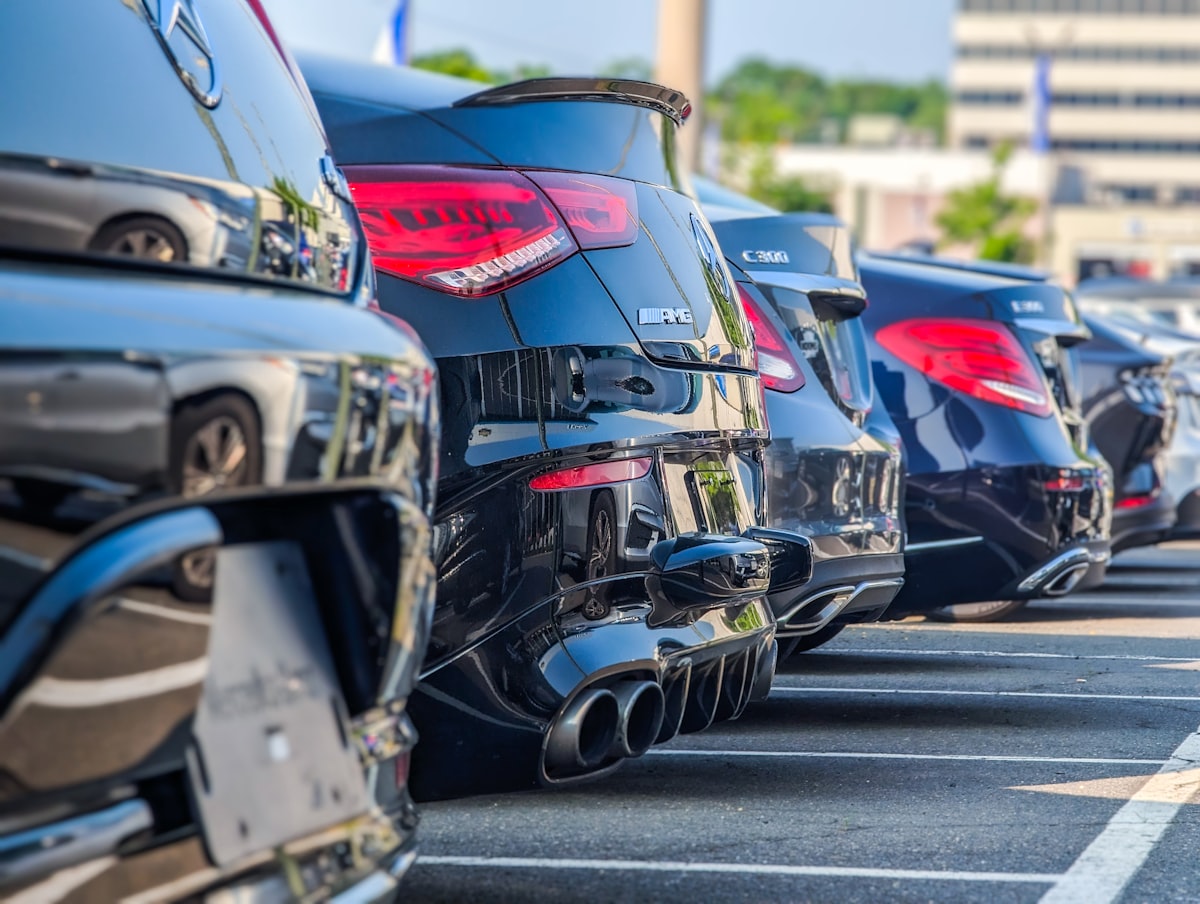 Row of sedans lined up at a dealership lot