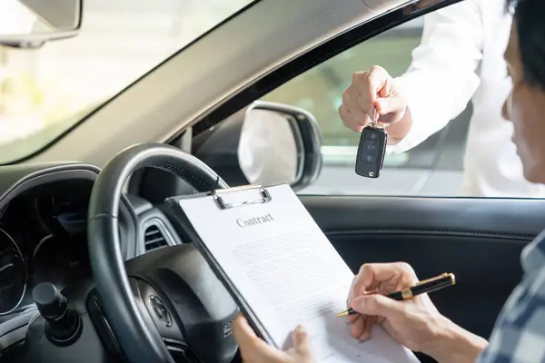 New car keys on a lease agreement at a dealership