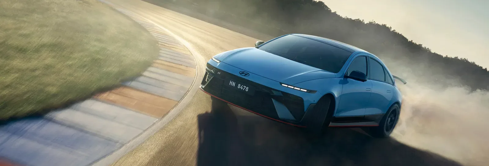 Hyundai IONIQ-branded electric vehicle in motion against a clean studio backdrop