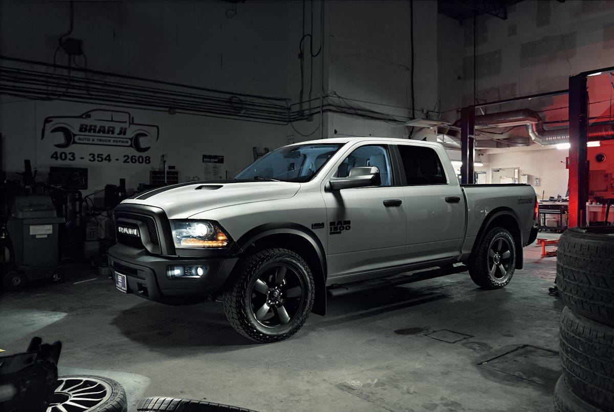 Ram 1500 pickup truck in a garage under dramatic lighting